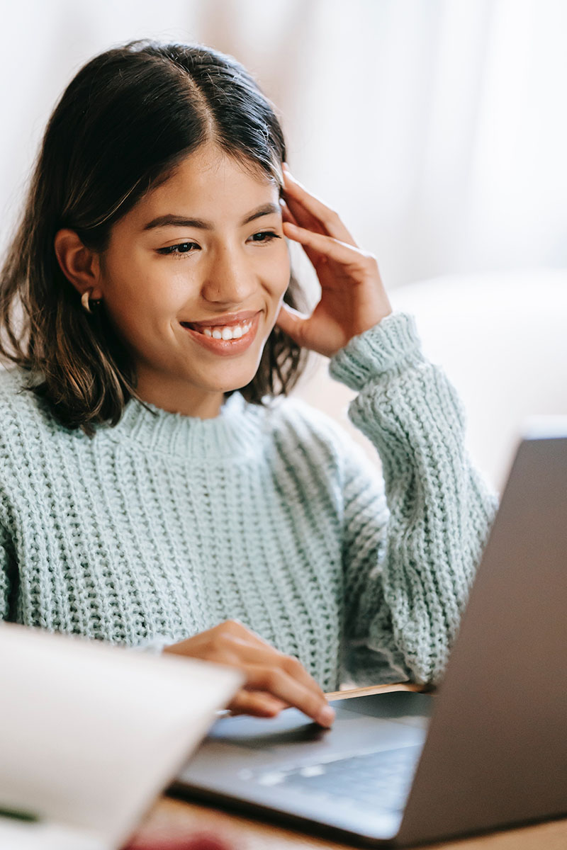 Woman smiling using a computer